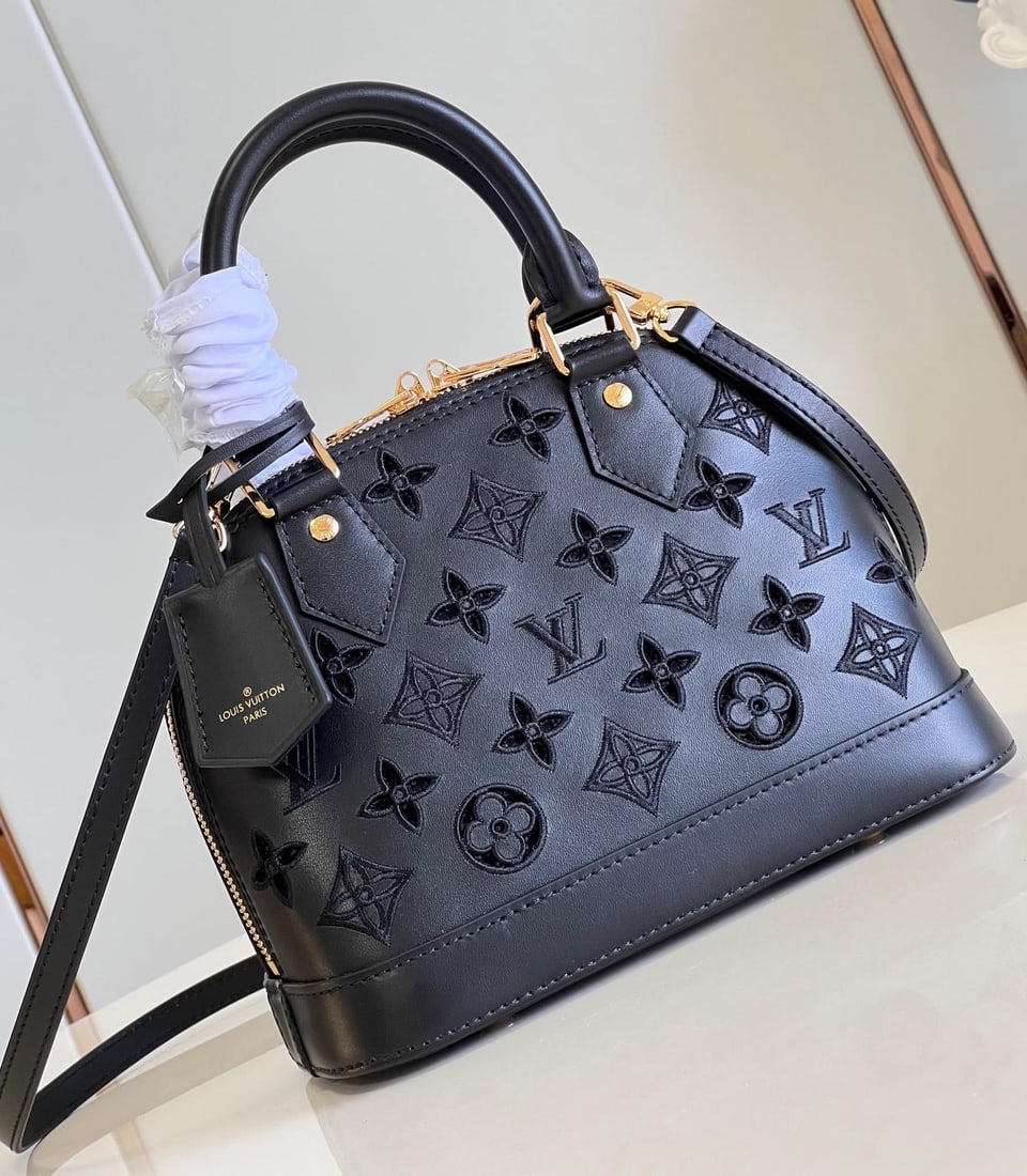 LV Alma BB: This Alma BB handbag is from this season's LV Broderie Anglaise collection. The supple calfskin is adorned with the iconic Monogram perforated pattern, creating a captivating and unique design. The op
