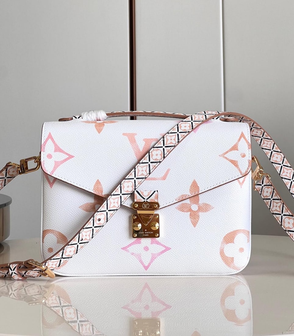 LV Pochette Metis: The Pochette Metis handbag features a watercolor effect of LV monogram and Monogram flowers on canvas, with intricate Monogram flowers adorning the top handle and detachable shoulder strap, drawing