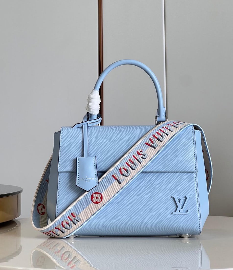 LV Cluny: The Cluny BB handbag features a novel twill pattern on Epi leather, paired with a smooth resin LV logo and a bright lining. The detachable reversible shoulder strap, with its vibrant jacquard, exudes 