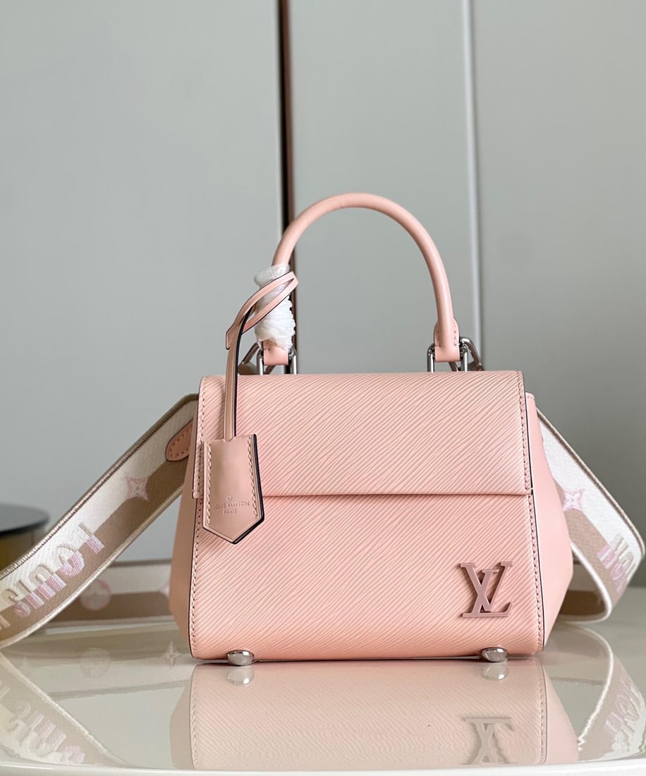 LV Cluny: The Cluny mini handbag showcases two styles with its detachable jacquard shoulder strap: the LV logo proclaims the brand identity, while flipping it reveals the subtle blooming of the Monogram flower.