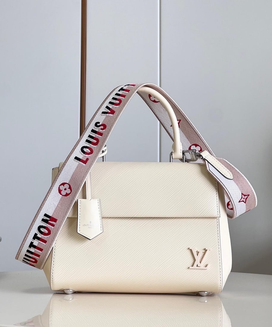 LV Cluny: The Cluny BB handbag features a novel twill pattern on Epi leather, paired with a smooth resin LV logo and a bright lining. The detachable reversible shoulder strap, with its vibrant jacquard, exudes 
