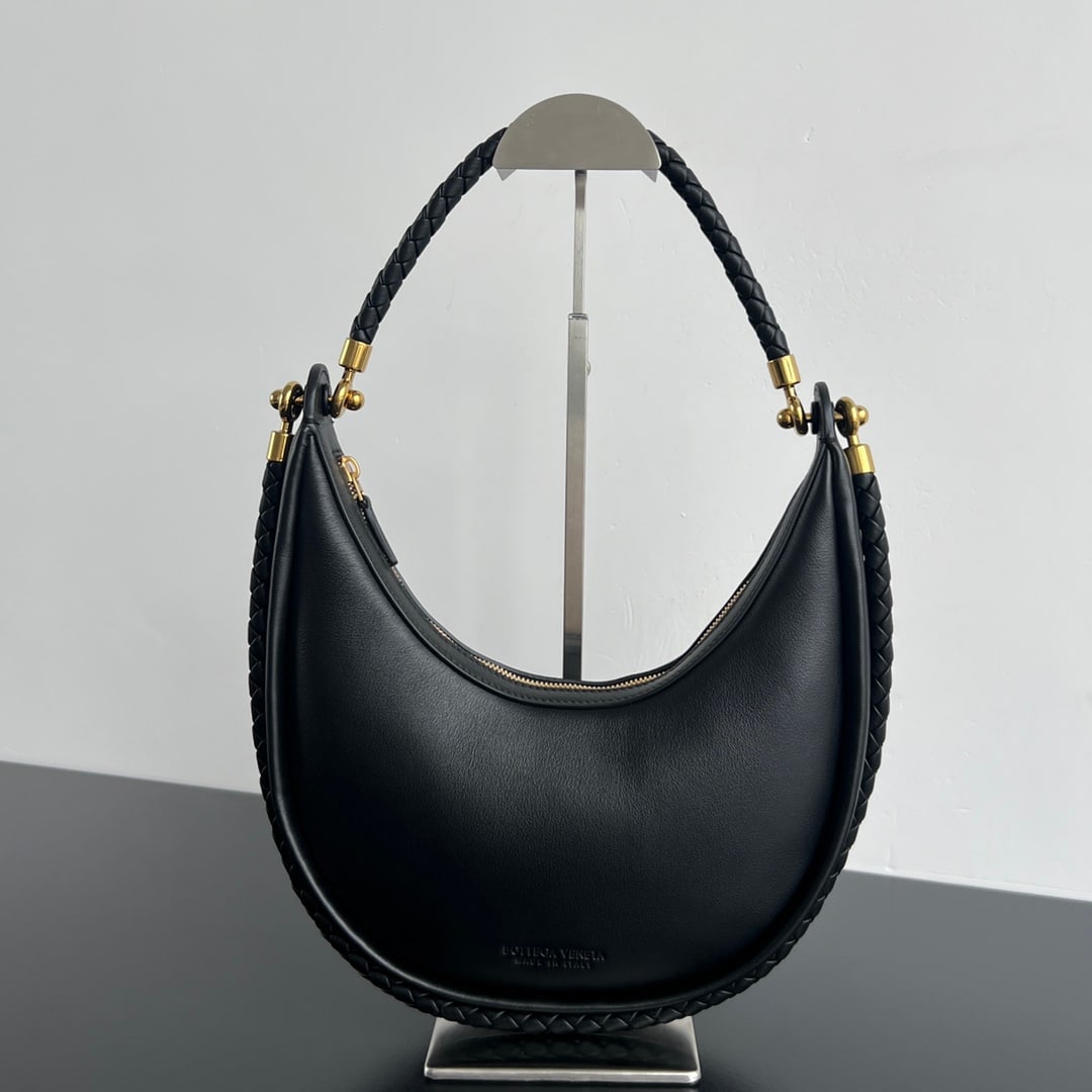 Bottega Veneta Half-Moon Bag: The Bottega Veneta Half Moon Bag is an exquisite yet relaxed half moon bag crafted from imported lambskin, offering a delicate and soft touch. A round buckle cleverly connects two hand-woven shoulder 