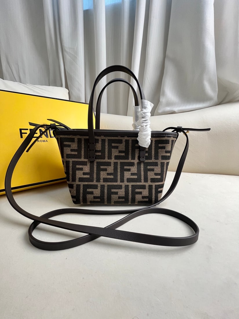 Fendi Roll: This mini roll bag features a retro-chic design in dark brown calfskin leather with lettering. The included long calfskin shoulder strap is detachable, allowing for crossbody or hand carry. It's spaci