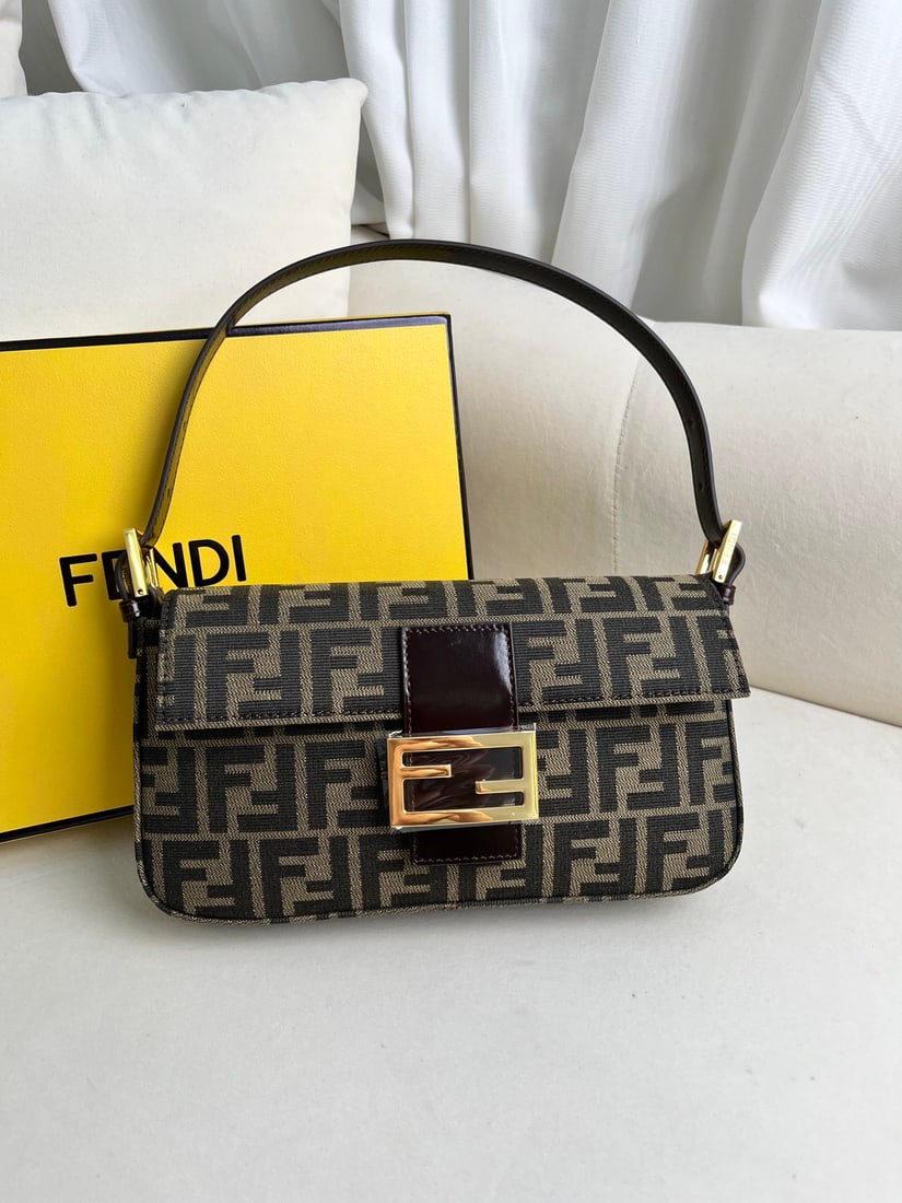Fendi Baguette: This gold-buckled Baguette bag is elegant, stylish, and exquisitely crafted. Based on a classic rectangular design, it is embellished with details that enhance its timeless appeal. Dimensions: 26 x 15