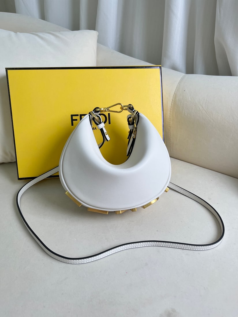 Fendi Praphy: This small white Praphy underarm bag features a crescent shape and a classic large metal logo at the bottom. Its silhouette hugs the body's lines, creating a stylish look when worn under the arm. Smal