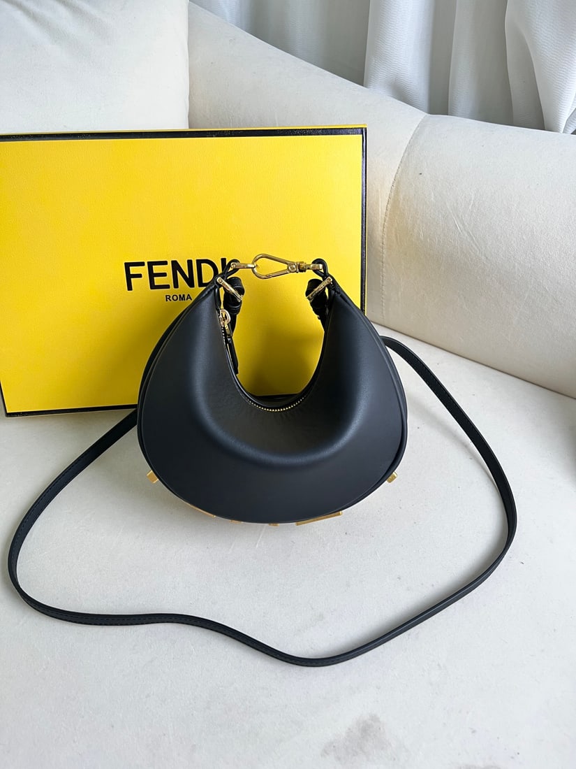 Fendi Praphy: This small black Praphy underarm bag features a crescent shape and a classic large metal logo at the bottom. Its silhouette hugs the body's lines, creating a stylish look when worn under the arm. Smal