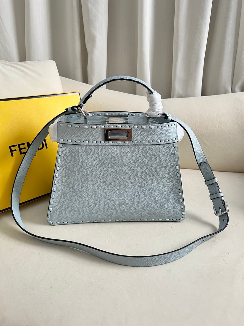 FENDI PeekabooISeeU: This light blue FENDI Peekaboo I See U medium-sized handbag is crafted from pebbled calfskin leather, featuring classic twist locks on both sides, a soft Nappa leather lining, two compartments