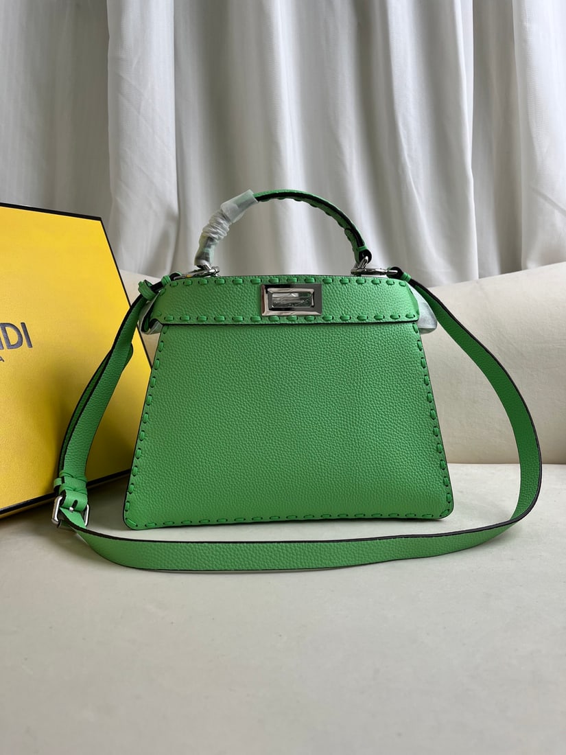 FENDI PeekabooISeeU: The green FENDI Peekaboo I See U medium handbag is crafted from pebbled calfskin, featuring classic twist locks on both sides, a soft Nappa leather lining, two compartments separated by a rigid