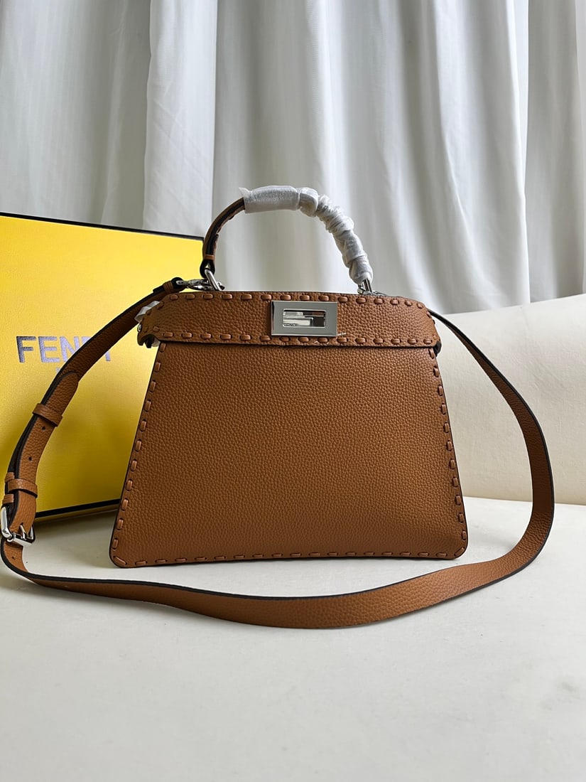 FENDI PeekabooISeeU: This brown FENDI Peekaboo SeeU medium-sized handbag is crafted from pebbled calfskin leather, featuring classic twist locks on both sides, a soft Nappa leather lining, two compartments separated by a