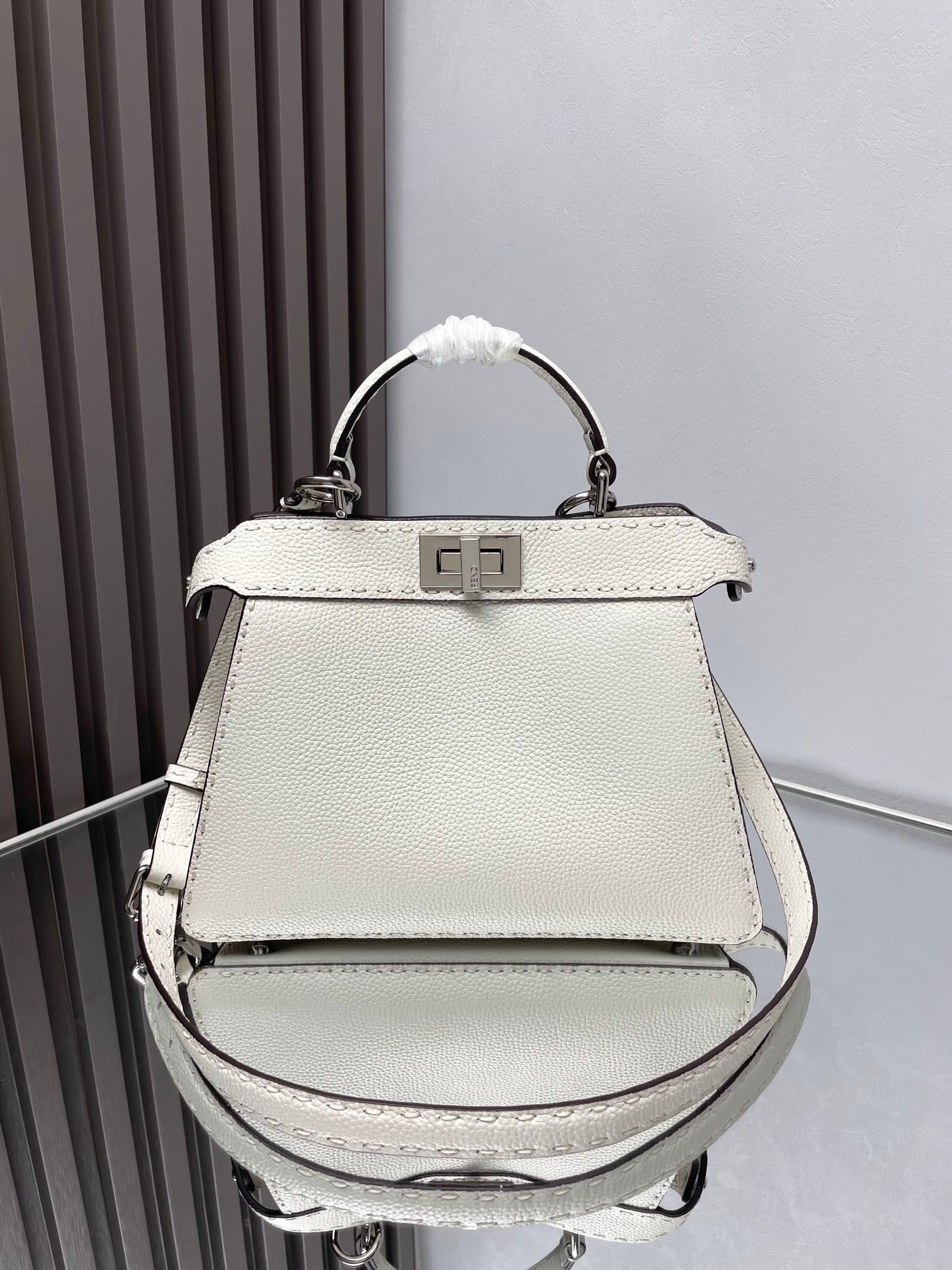 Fendi Iconic Peekaboo ISeeU: Iconic Peekaboo ISeeU Small Handbag, crafted from brown Cuoio Romano leather with hand-stitched color-matching details and classic twist locks on both sides. Lined with a leather Selleria stamp, the