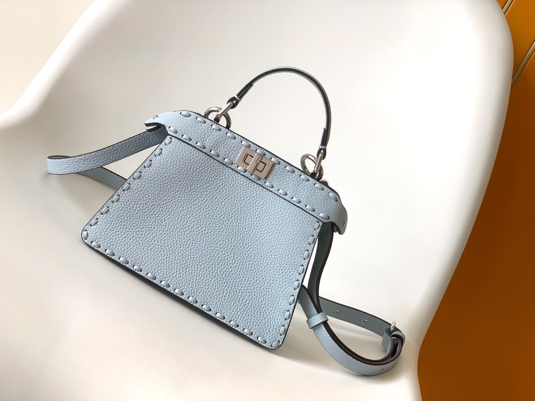 Fendi conic Peekaboo ISeeU Mini: Fendi conic Peekaboo ISeeU Mini is made of calfskin leather, with large, tonal stitching and hand-stitched details. It features a classic twist lock, two compartments, a handle, and an adjustable,