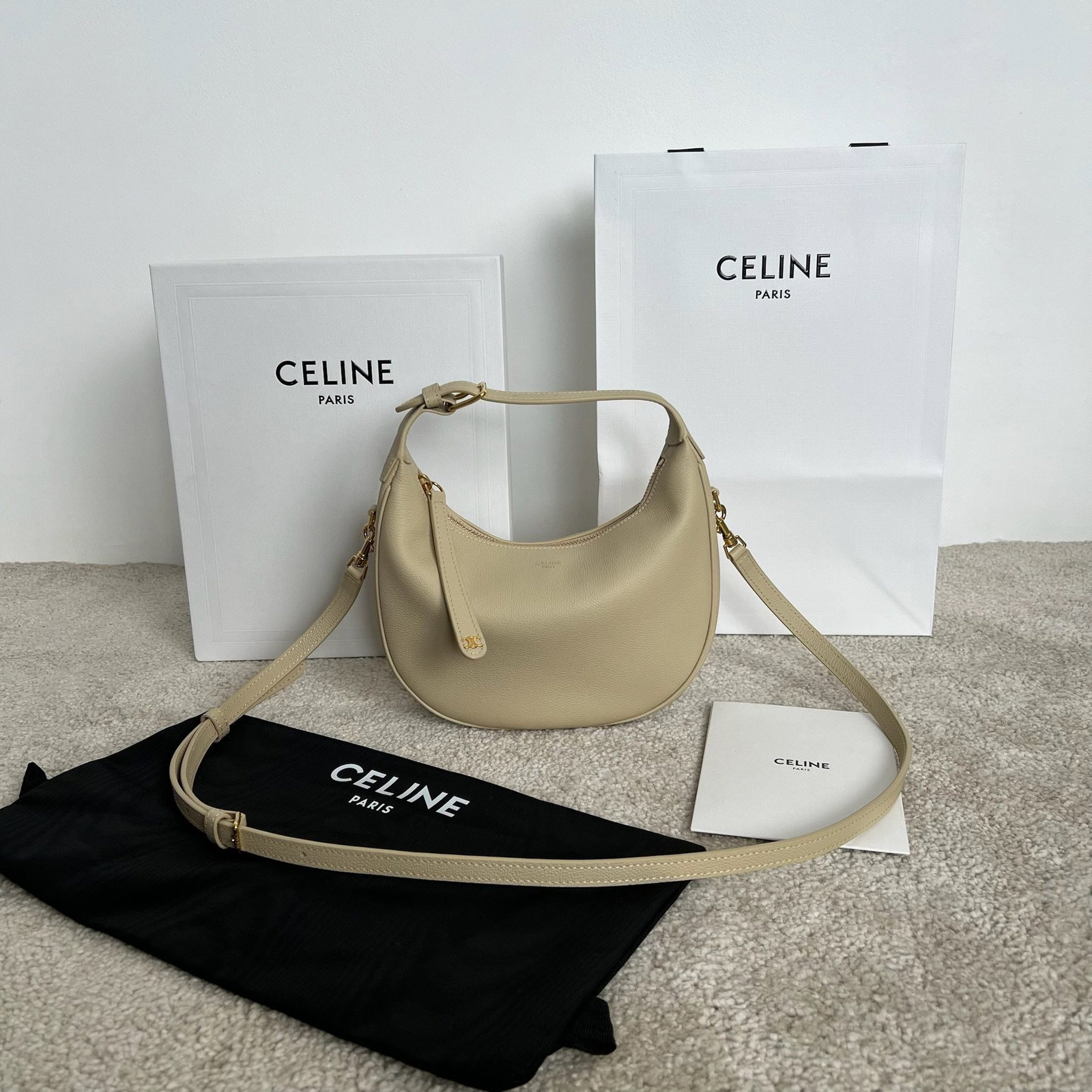Celine: TEEN LULU Soft Grained Calfskin Leather Handbag, Deep Ivory White. Can be carried by hand, over the shoulder, or crossbody. This model can accommodate large smartphones such as the Plus. 21 x 24 x 5 c
