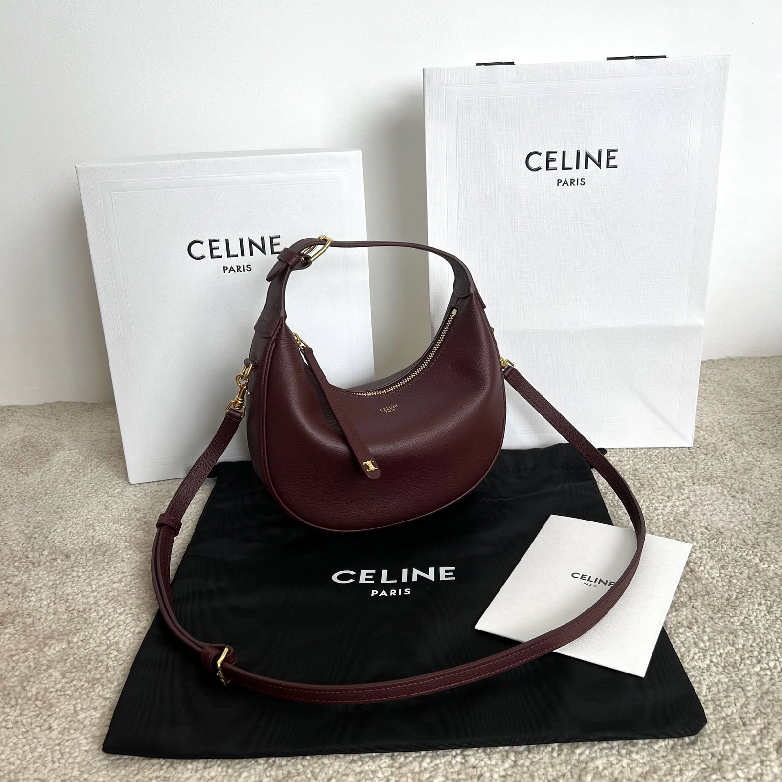 Celine: This TEEN LULU soft grained cowhide leather handbag can be carried by hand, over the shoulder, or crossbody. It can fit a large smartphone (21 x 24 x 5 cm). Features include cowhide leather, suede