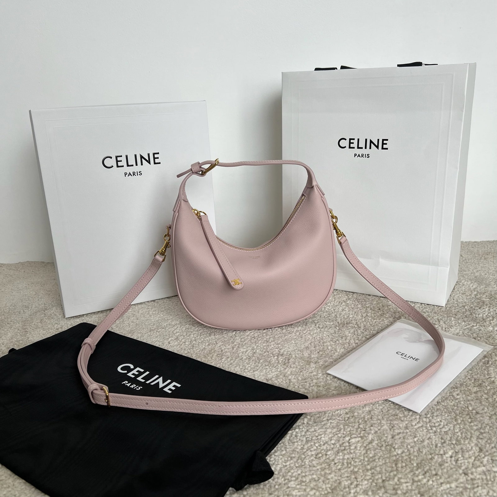 Celine: This TEEN LULU soft grained cowhide leather handbag can be carried by hand, over the shoulder, or crossbody. It can fit a large smartphone (21 x 24 x 5 cm). Features include cowhide leather, suede lin