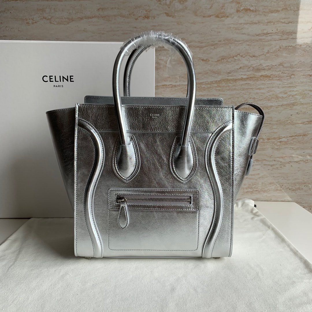 Celine Luggage Micro: Silver plain-grain LUGGAGE MICRO mini calfskin tote bag with leather handles, one zip closure, and one exterior zip pocket on the front. 11 x 11 x 6 inches (27 x 27 x 15 cm). 100% calfskin leather, si