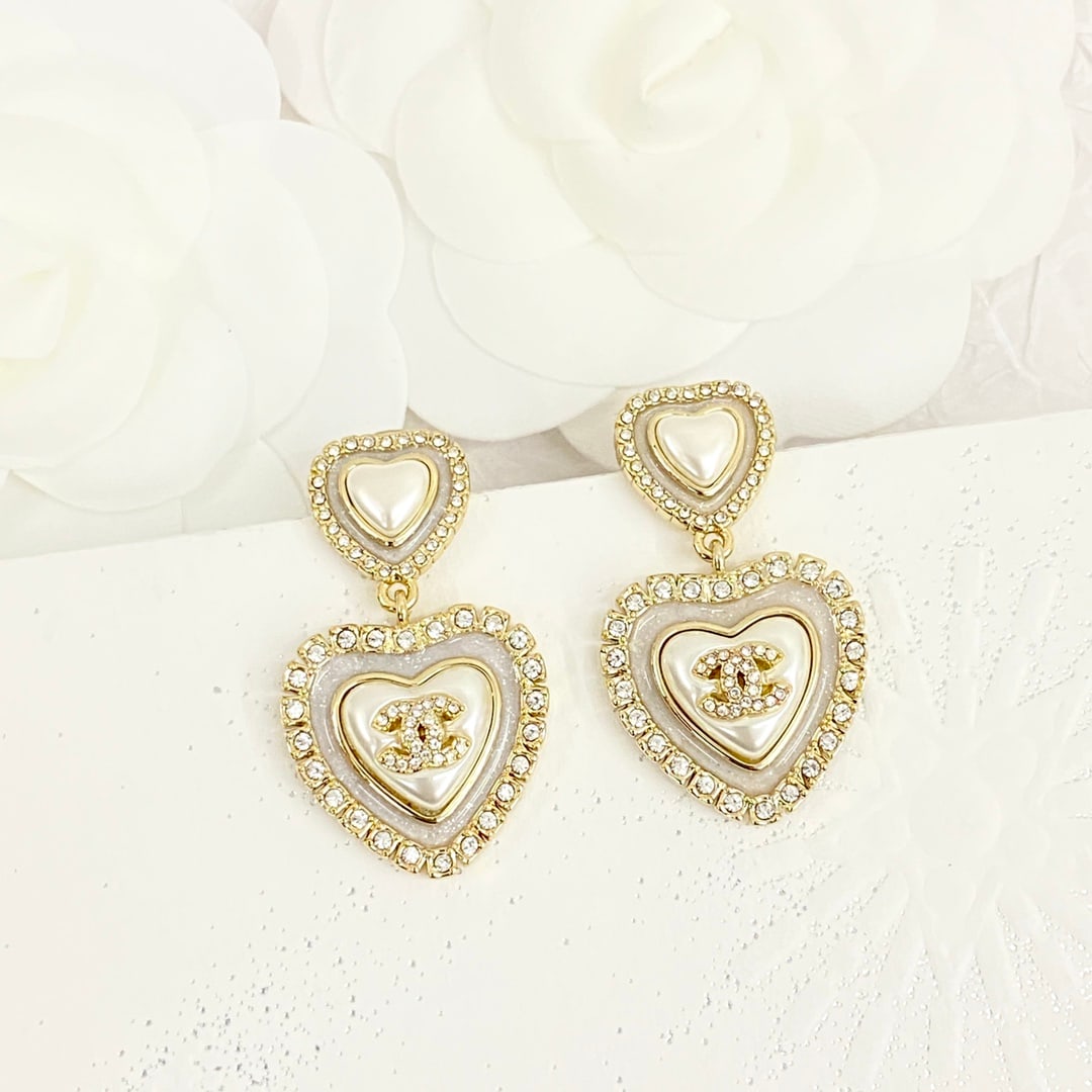 Chanel white mother-of-pearl double heart earrings: Chanel's white mother-of-pearl double heart earrings feature white mother-of-pearl embellishments and crystal settings, exuding a vintage yet elegant charm. The double heart pendant design is layered 