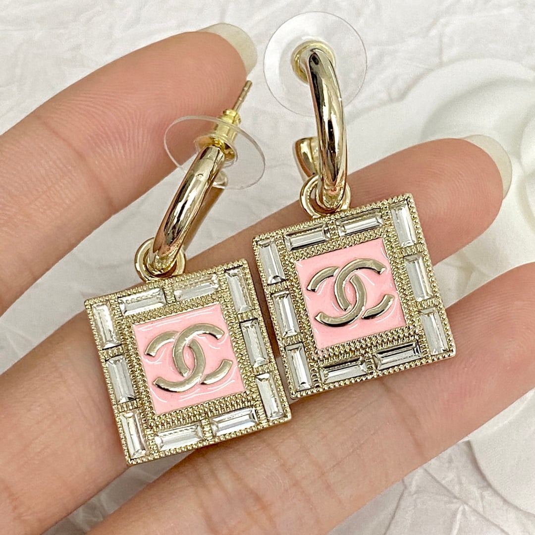 Chanel rhinestone square hook earrings: Chanel rhinestone square hook earrings feature a rectangular rhinestone border that exudes unique elegance. A shimmering gold "C" is set against a pink background, conveying both fashion and