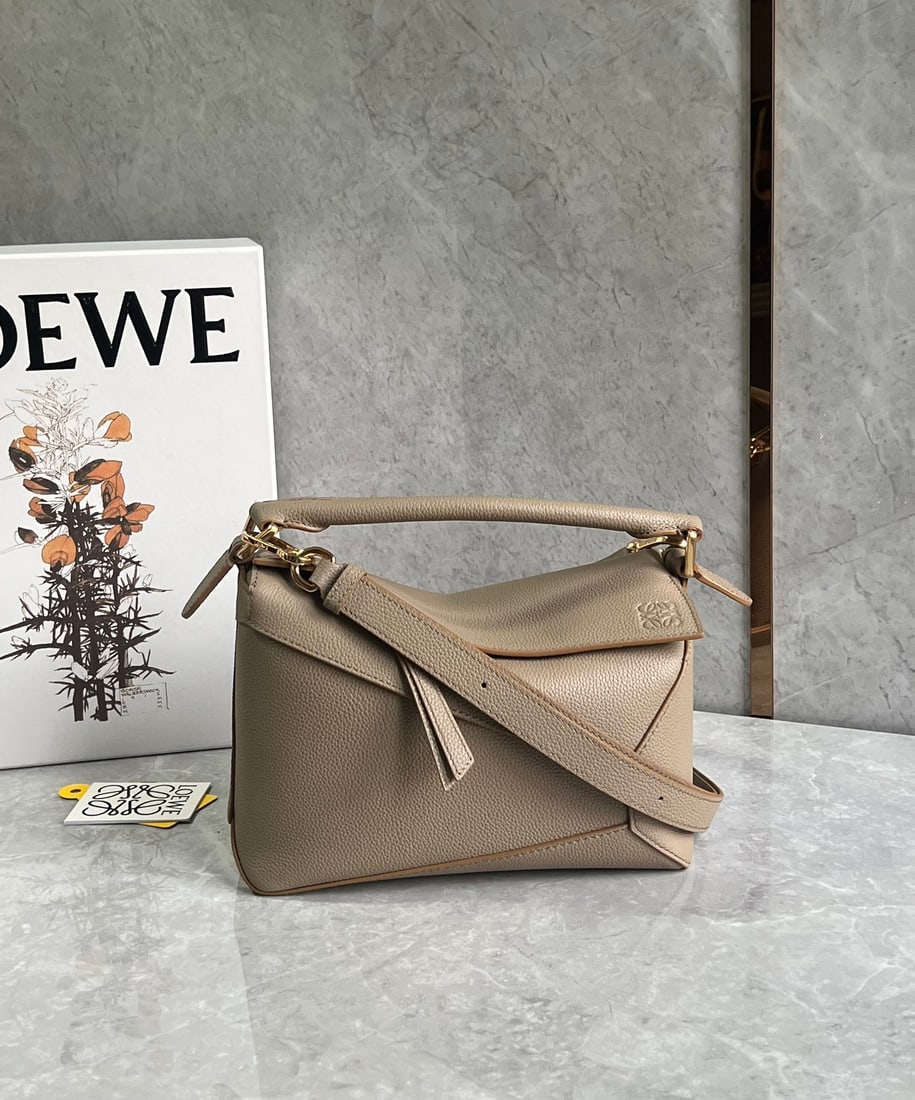 LOEWE: The LOEWE Puzzle bag is made of pebbled cowhide, with a sand-colored patchwork design throughout. It's lightweight yet has a surprisingly large capacity, making it practical, versatile, and
