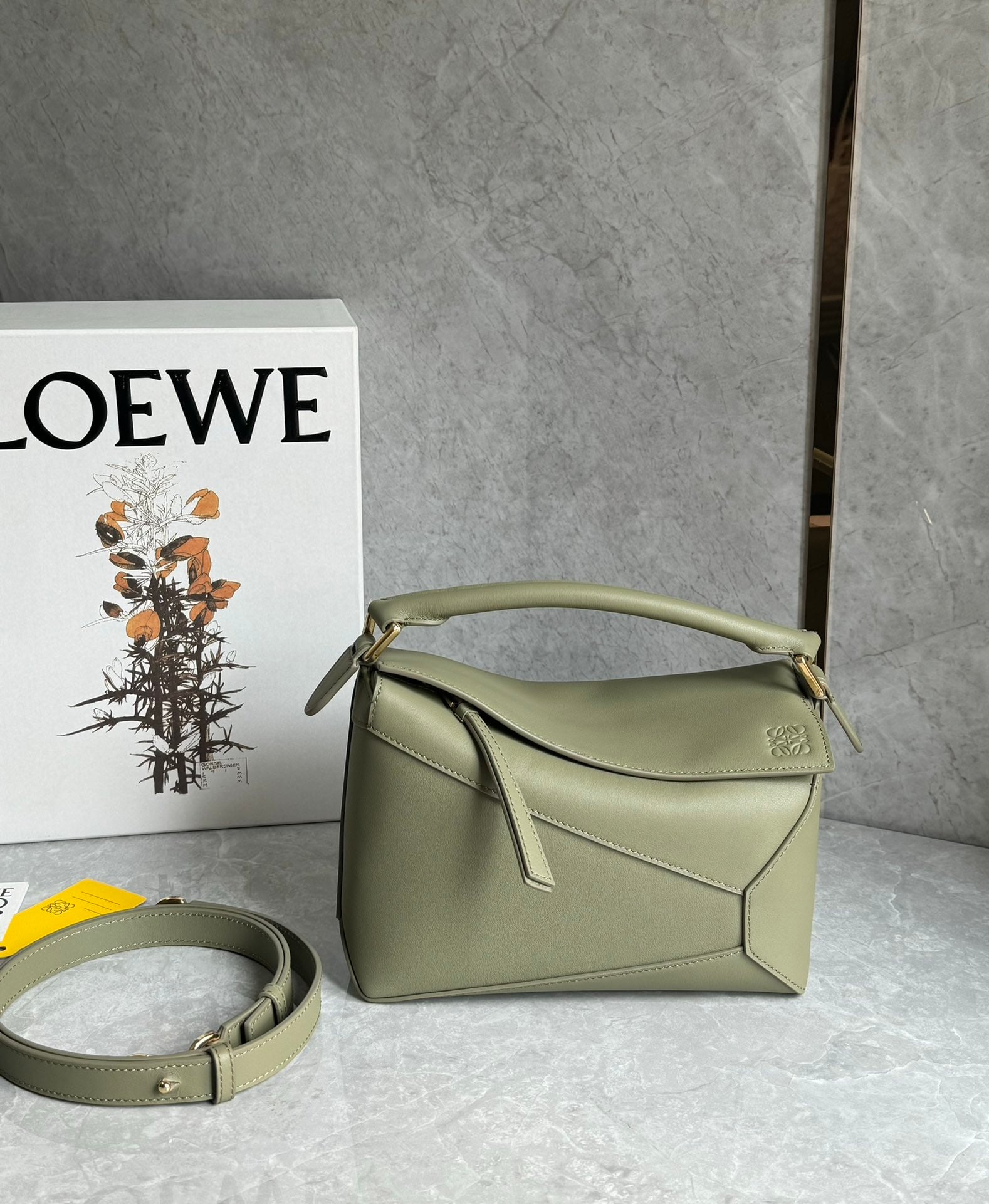 LOEWE: LOEWE Premium Eucalyptus Green Puzzle Bag is made of calfskin. The bag is lightweight yet has a surprisingly large capacity, making it practical, versatile, and convenient for travel. Small size: 24