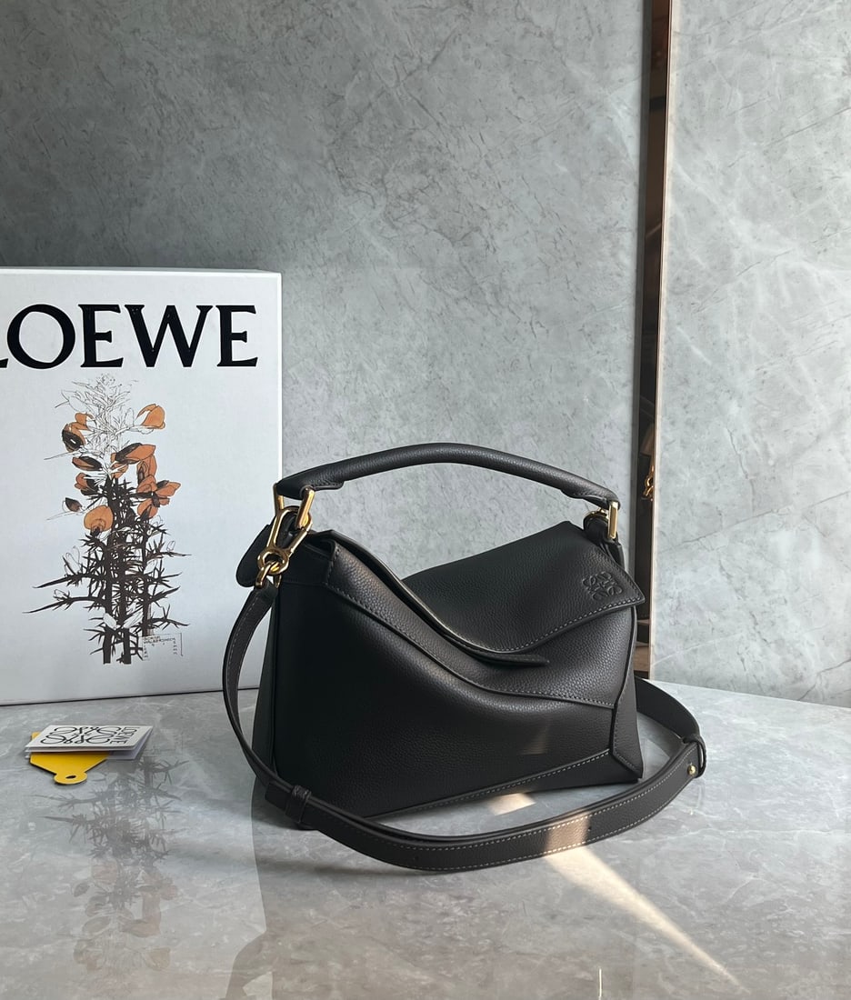 LOEWE: The LOEWE Puzzle bag is made of pebbled cowhide, with a sand-colored patchwork design throughout. It's lightweight yet has a surprisingly large capacity, making it practical, versatile, and