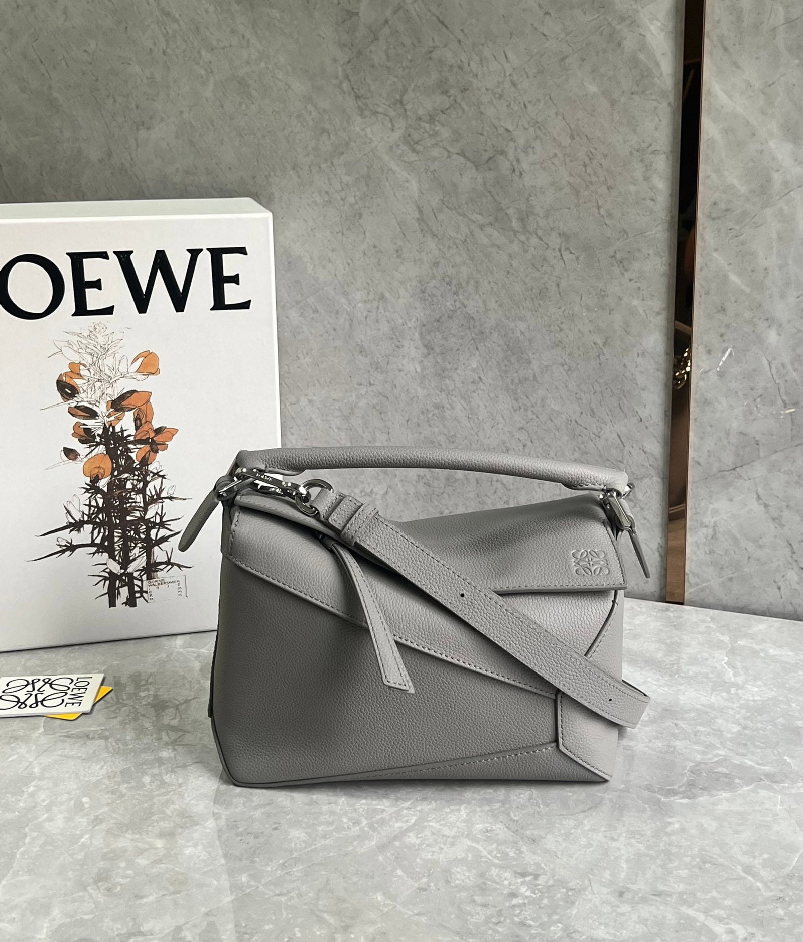 LOEWE: The LOEWE Puzzle bag is made of pebbled cowhide, with a sand-colored patchwork design throughout. It's lightweight yet has a surprisingly large capacity, making it practical, versatile, and