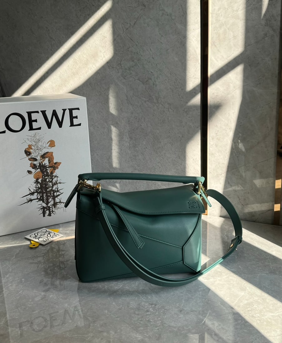 LOEWE: The LOEWE Vetiver Green Puzzle bag is made of calfskin. It's lightweight yet has a surprisingly large capacity, making it practical, versatile, and convenient for travel. Small size: 24 x 16 x 10 cm.
