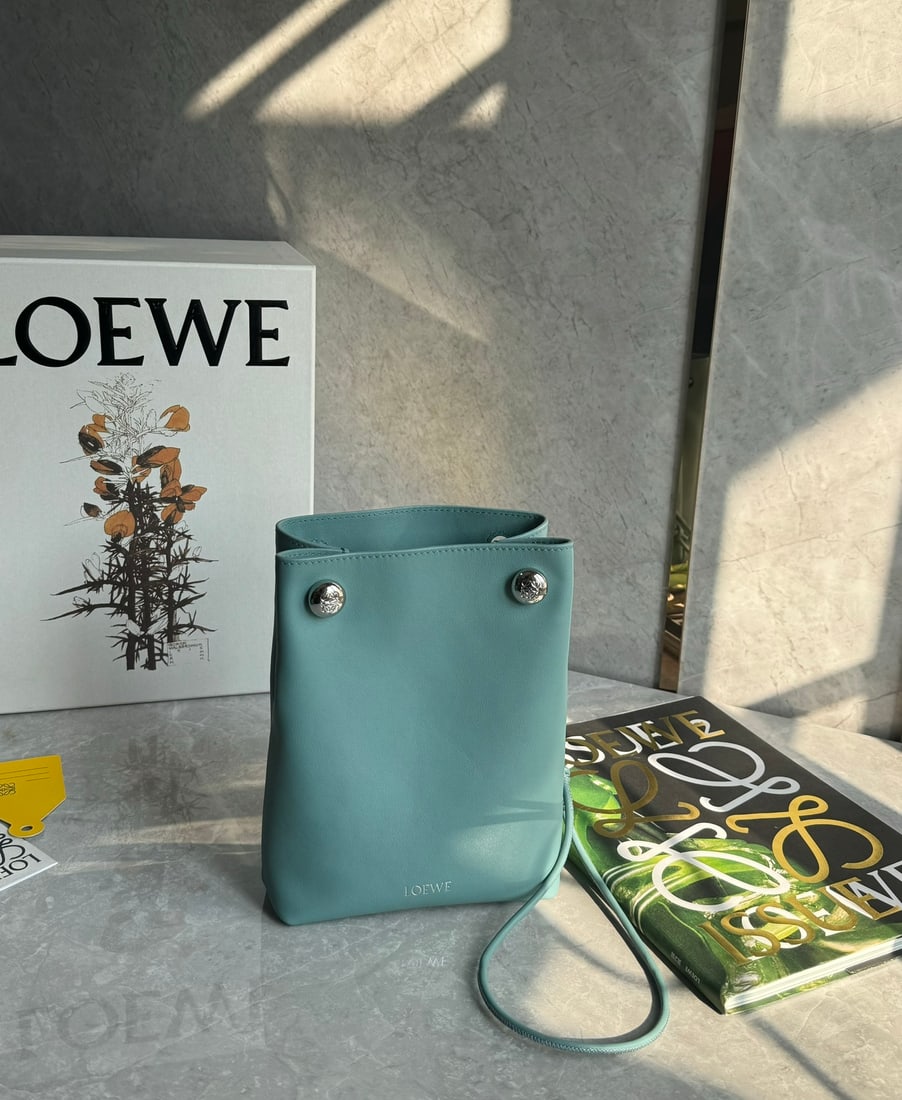 LOEWE: LOEWE Pebble Pouch: Small in size but surprisingly spacious, this bag can be worn under the arm or crossbody! Made of smooth cowhide leather, this foldable pouch features an adjustable tubular