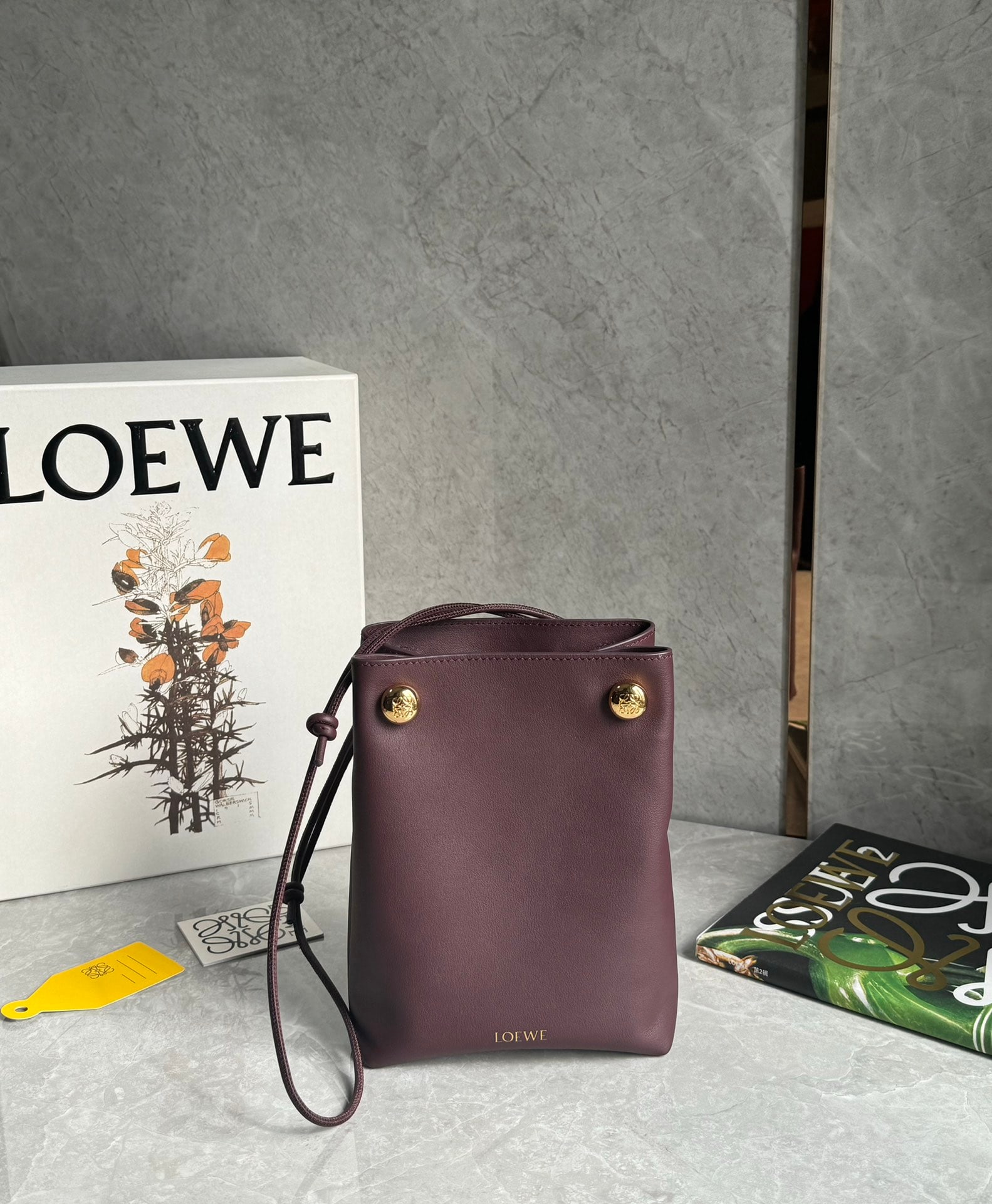 LOEWE: LOEWE Pebble Pouch: Small in size but surprisingly spacious, this bag can be worn under the arm or crossbody! Made of smooth cowhide leather, this foldable pouch features an adjustable tubular