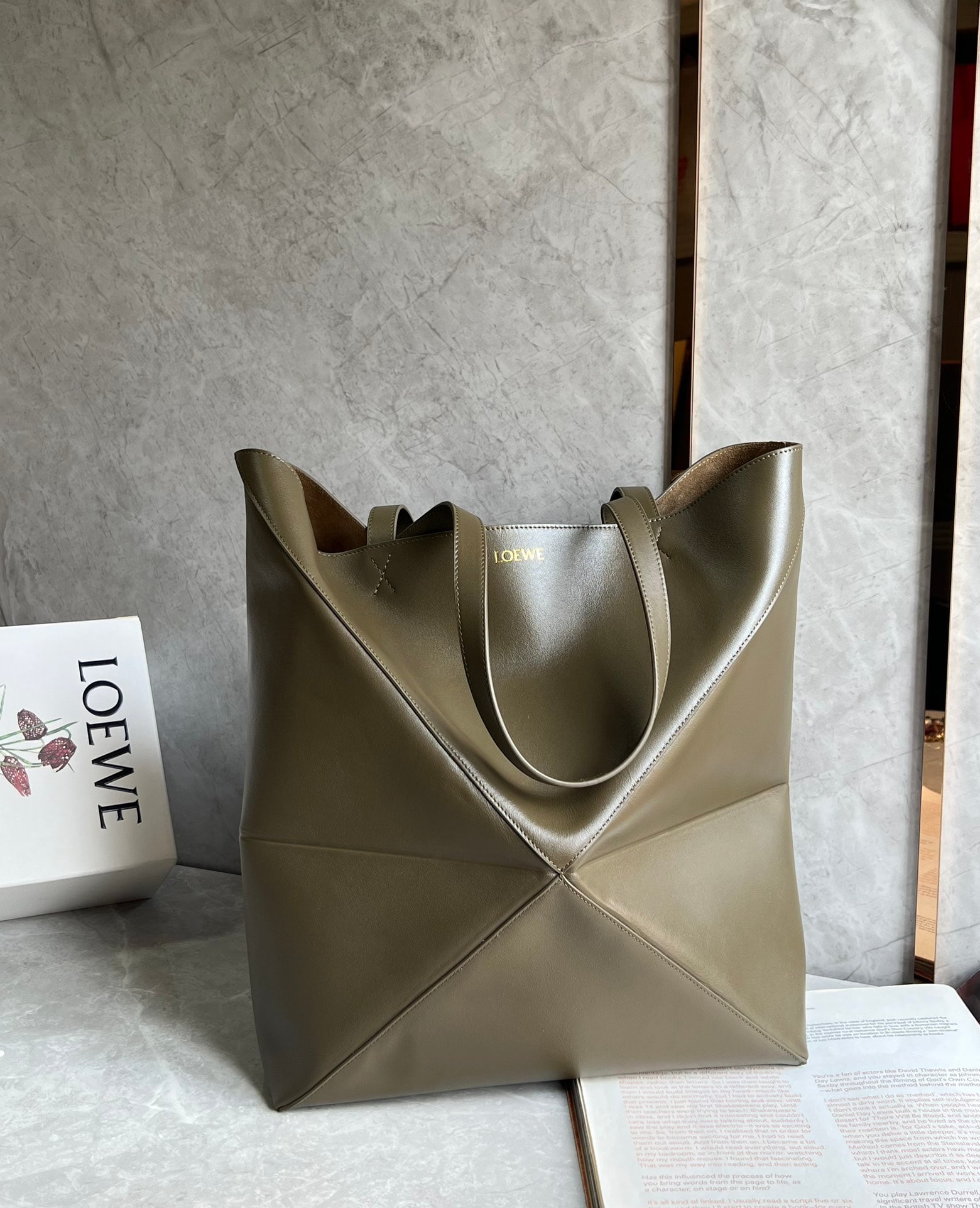 LOEWE: The LOEWE Puzzle Fold Tote is crafted entirely from Nappa calfskin. Inspired by origami, the Puzzle Fold Tote boasts clean lines and an understated elegance. It's incredibly soft, spacious, and its mo