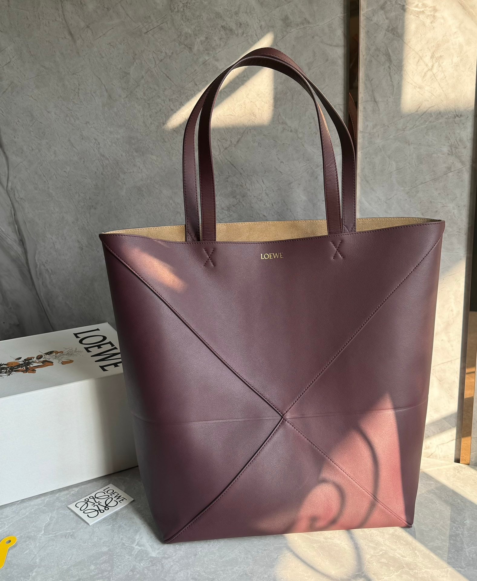 LOEWE: The LOEWE Puzzle Fold Tote is crafted entirely from Nappa calfskin. Inspired by origami, the Puzzle Fold Tote boasts clean lines and an understated elegance. It's incredibly soft, spacious, and its mo