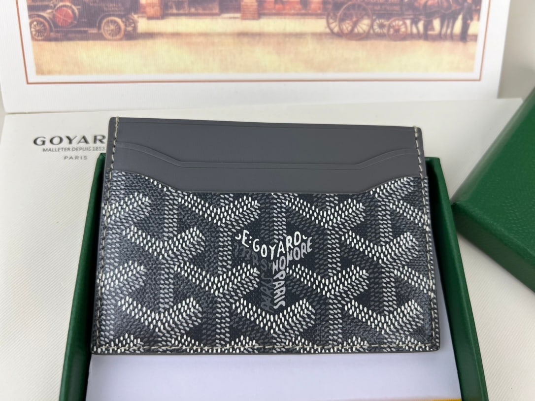 Goyard Saint-Sulpice: The Goyard Saint-Sulpice cardholder features a compact design with a central pocket for cards, ID cards, or folded banknotes. Its petite size makes it perfect for a jacket or trouser pocket. The card 