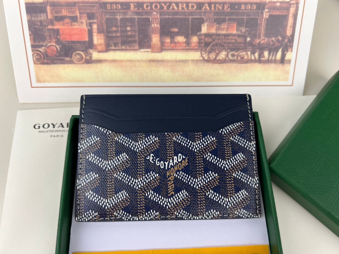 Goyard Saint-Sulpice: The Goyard Saint-Sulpice cardholder features a compact design with a central pocket for cards, ID cards, or folded banknotes. Its petite size makes it perfect for a jacket or trouser pocket. The card