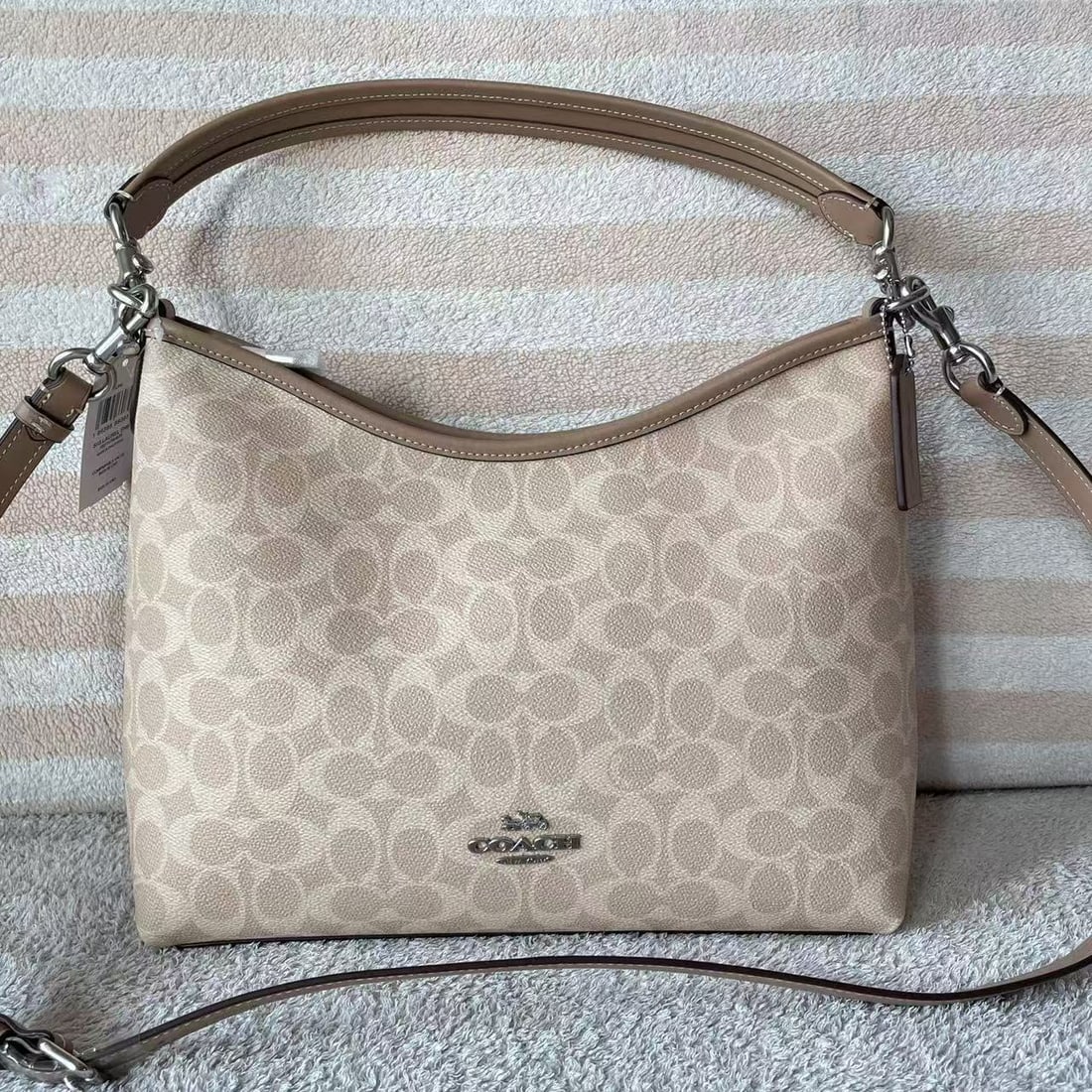 COACH laurel: The Laurel hobo bag is a signature coated monogrammed shoulder/crossbody bag made of top-grain cowhide leather. It features two shoulder straps of varying lengths, allowing for hand-carrying, shoulder