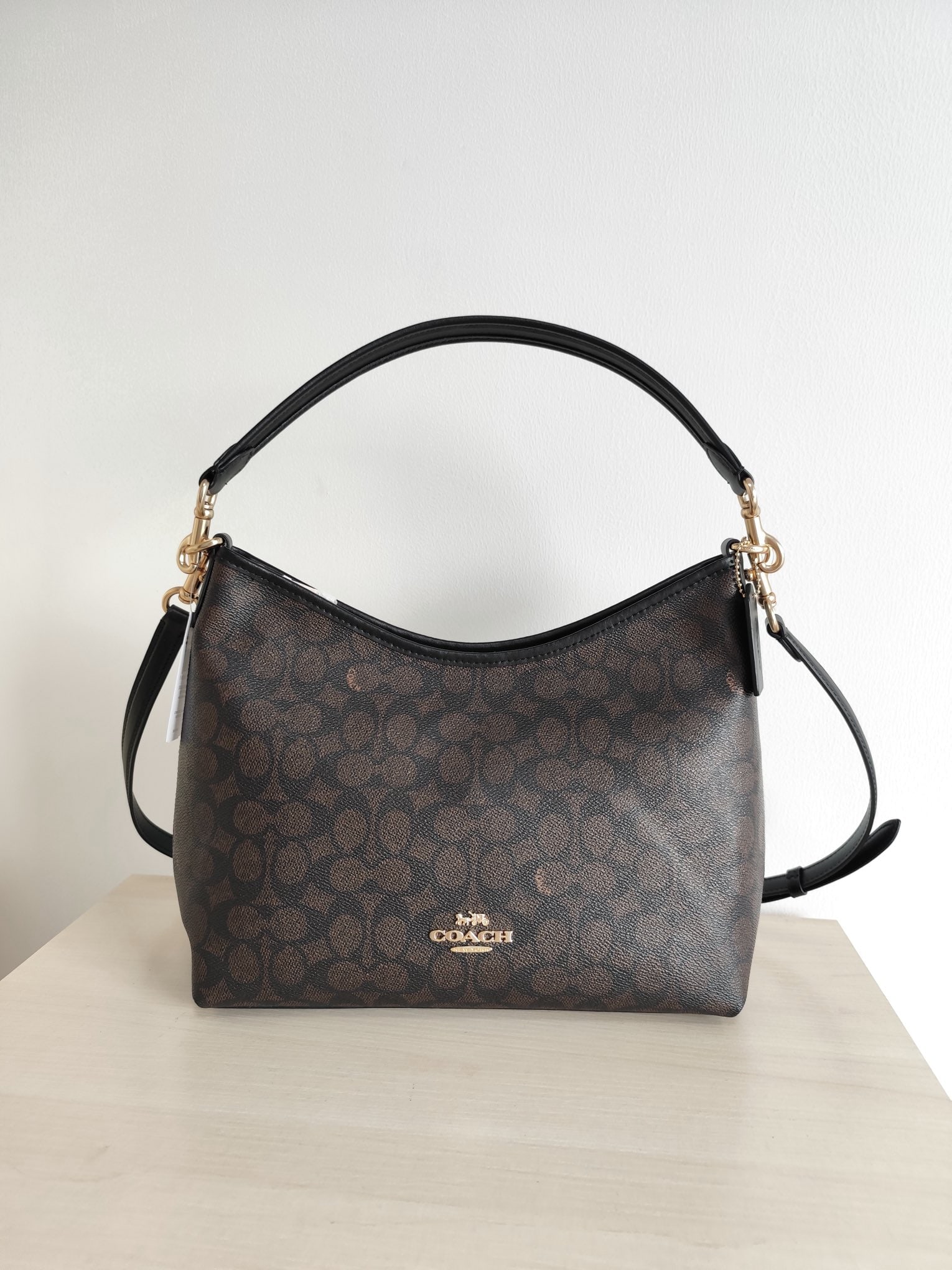 COACH laurel: COACH Laurel Hobo Bag, a shoulder/crossbody bag featuring the brand's signature coated monogram canvas and top-grain cowhide leather. It comes with two shoulder straps (one long and one short) for