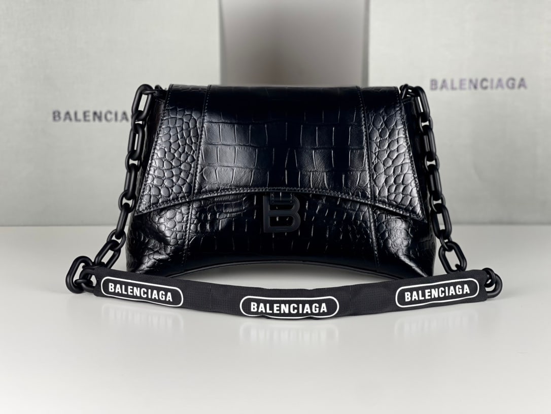 Balenciaga Downtown Chain Shoulder Bag: The black Balenciaga Downtown chain shoulder bag with crocodile-embossed leather features the same sharp angles and contours as the classic Hourglass design. The hardware and bicycle lock-like chain s
