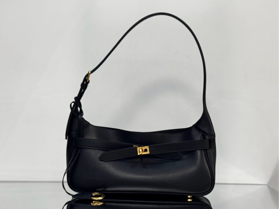 Balenciaga belair shoulder bag: Balenciaga Belair shoulder bag, soft and textured with gold-tone hardware, features a detachable key ring with two buckle turn lock closure and a buckle strap closure system. It also includes an engra