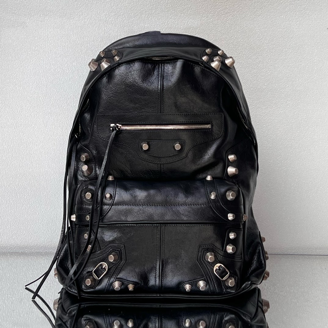Balenciaga studded backpack: The Balenciaga Le Cagole studded backpack is made of Italian cracked lambskin, making it soft and comfortable. It retains the classic biker style while adding a touch of cool. The Balenciaga has a