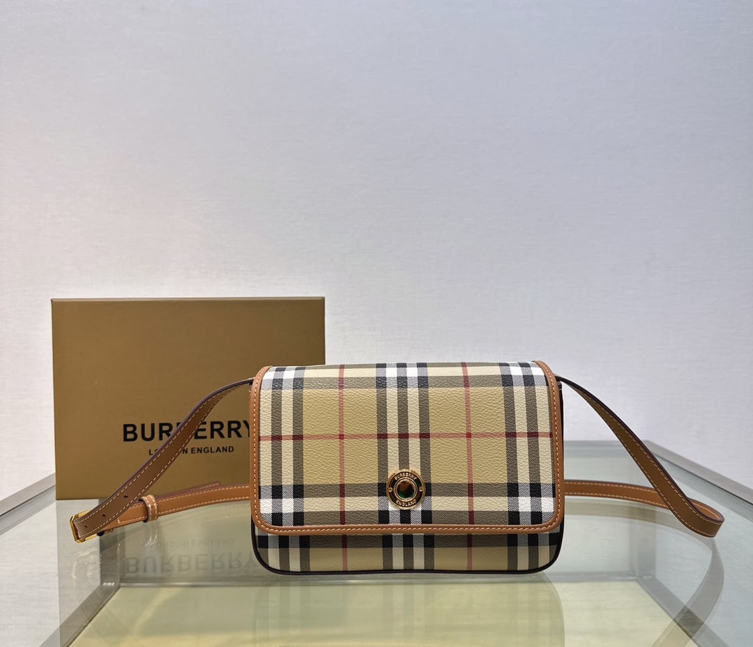 Burberry: A sophisticated Burberry bag crafted from smooth calfskin and adorned with Burberry's signature check pattern. It features a detachable shoulder strap that can be adjusted to function as a crossbody