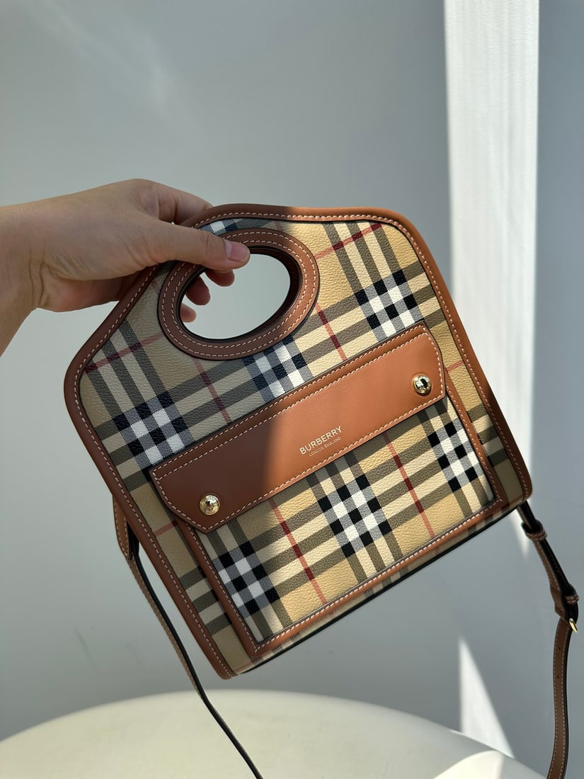 Burberry London: The Burberry London checkered canvas and leather patchwork tote bag is a timeless design inspired by classic tote bags. Made from sturdy, eco-friendly checkered canvas, it's waterproof,
