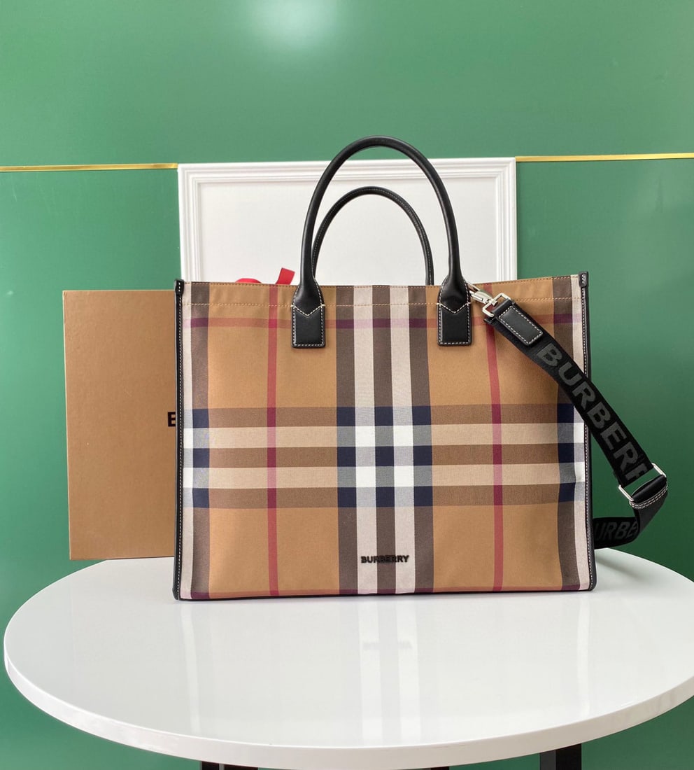 Burberry: Check out this Burberry bag with its checkered fabric lining and full-grain leather upholstery. True luxury is found inside, while the exterior remains understated. It boasts ample storage space, maki