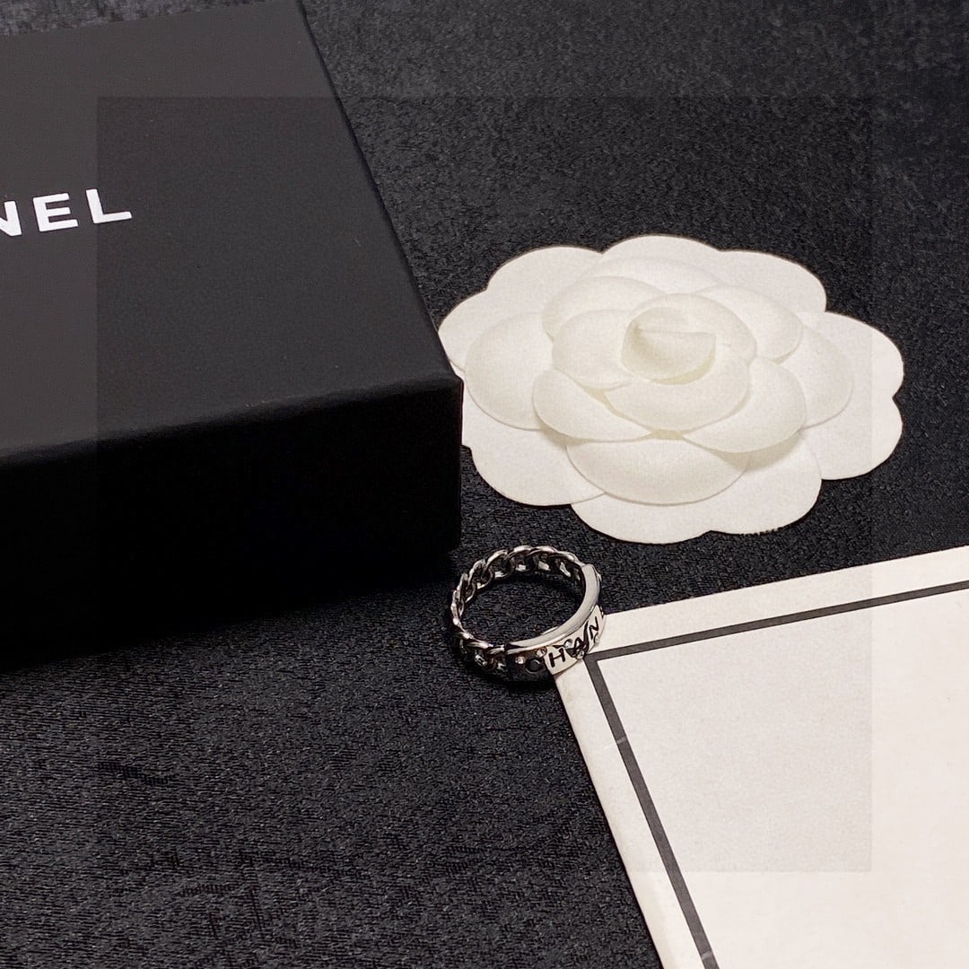 Chanel's double C logo ring with diamond design.: Chanel's double C logo ring with diamond accents! The simple design is incredibly sophisticated, makes your hands appear whiter, and is very versatile, easily layered with other styles. Thank you for