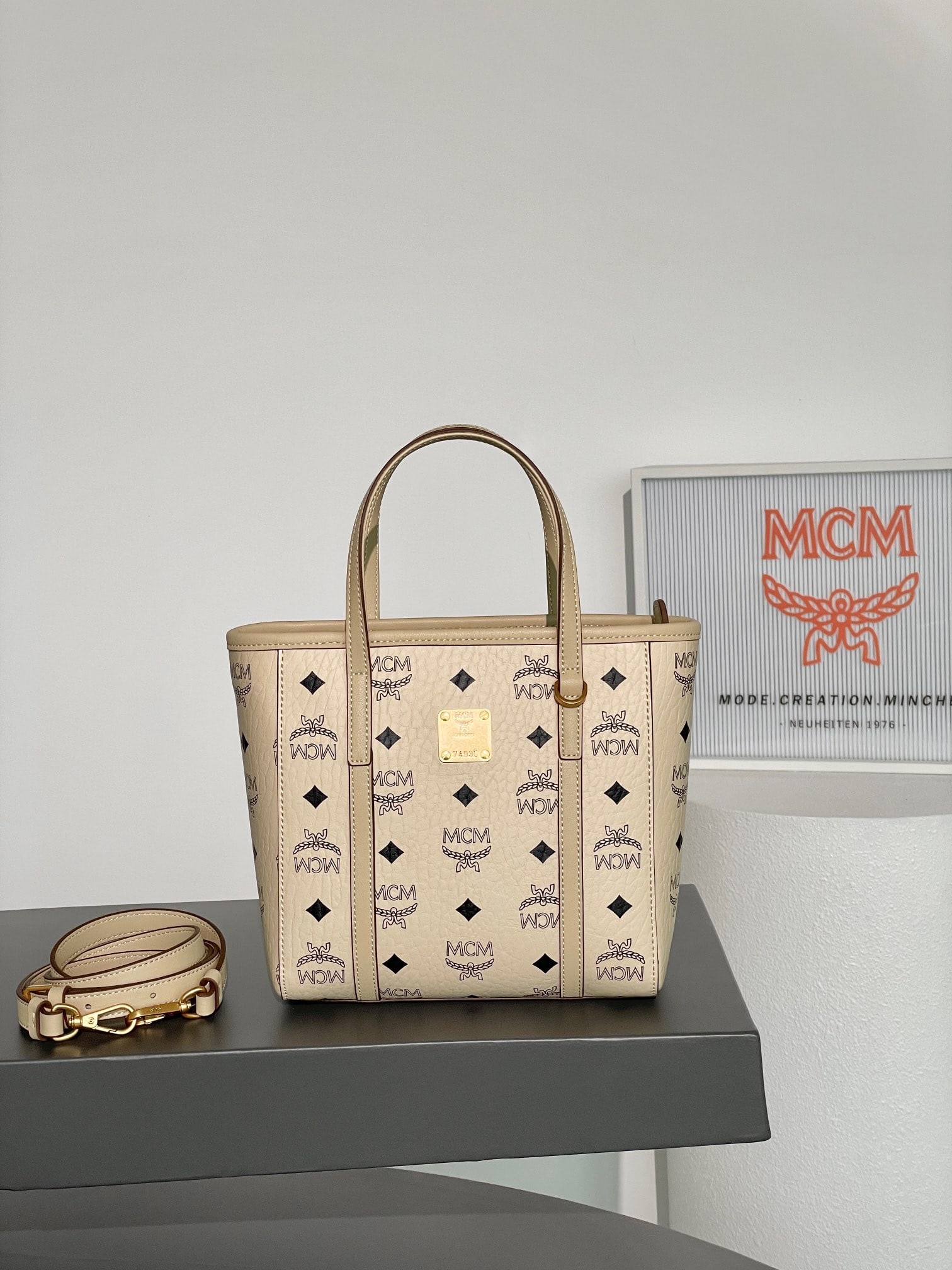 MCM AREN VISETOS MINI Cabbage Basket: MCM AREN VISETOS MINI Beige Basket Bag with All-over Monogram Print. This mini Aren tote bag is made by the iconic Visetos and trimmed with Nappa leather. The bag features a unique and practical geome