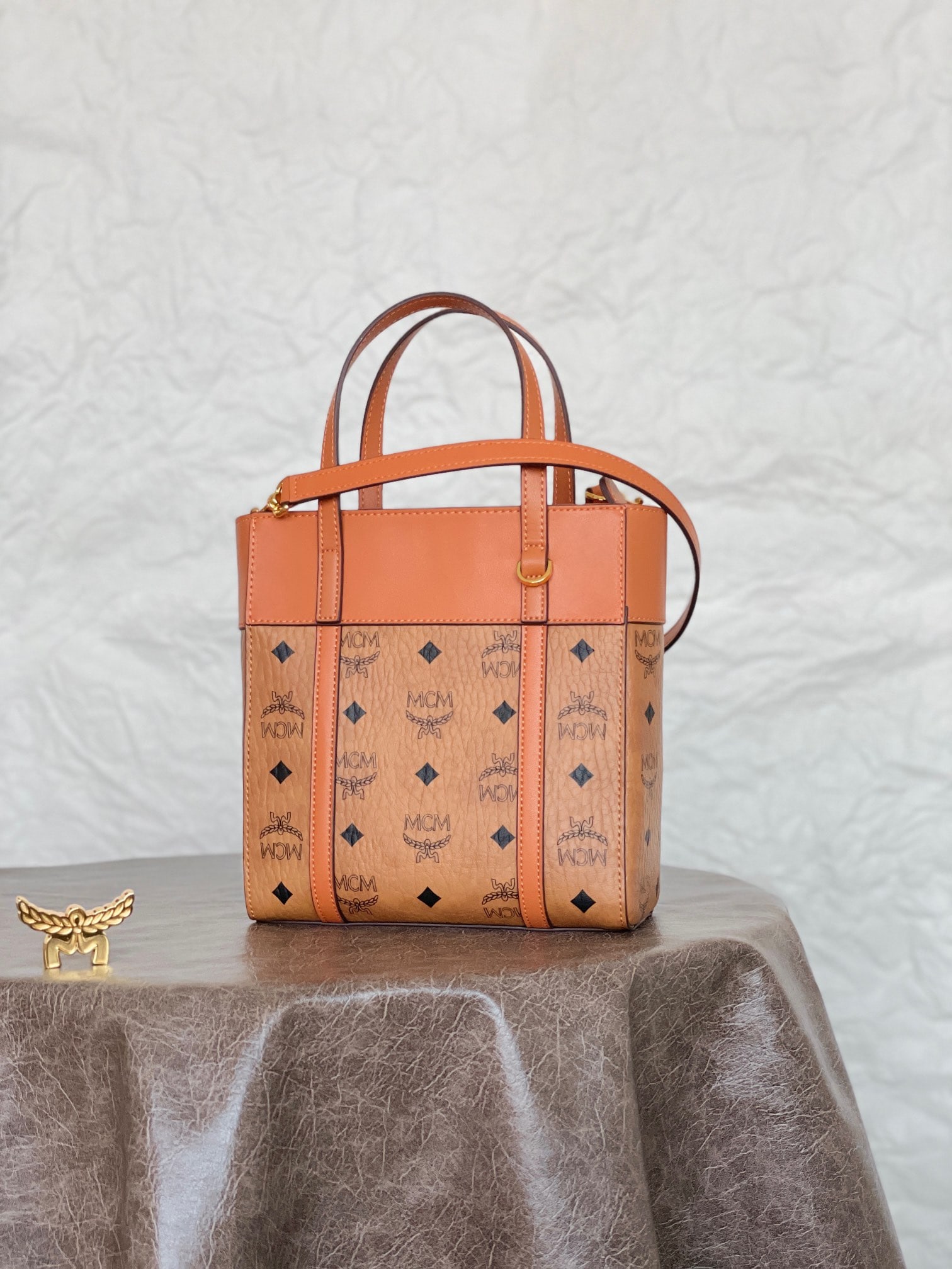 MCM AREN VISETOS MINI Mix and Match Shopping Bag: MCM AREN VISETOS MINI Mix-and-Match Shopping Bag in Classic Cognac. This mini Aren top-zip shopping bag is a new design for Spring/Summer 2023, featuring striking Spanish calfskin trim that outlines