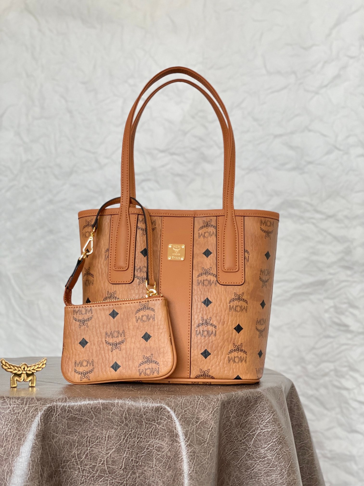 MCM LIZ VISETOS MINI Reversible Shopping Tote Bag: MCM LIZ VISETOS MINI Reversible Tote Bag in Classic Cognac Brown. Classic MCM minimalism is presented through a modern, minimalist design. This mini tote bag is a scaled-down version of the iconic Liz