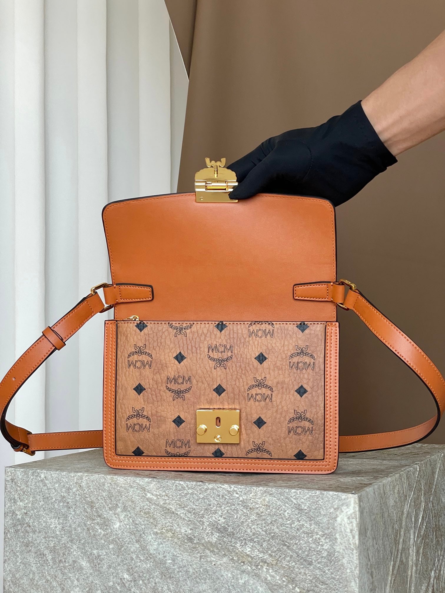 MCM TARCY VISETOS Crossbody Shoulder Strap Flap Bag: MCM TARCY VISETOS Crossbody Shoulder Strap Flap Bag in Cognac with All-over Monogram Print. This Tracy shoulder bag offers a modern interpretation of the classic Satchel bag. Crafted from the classic