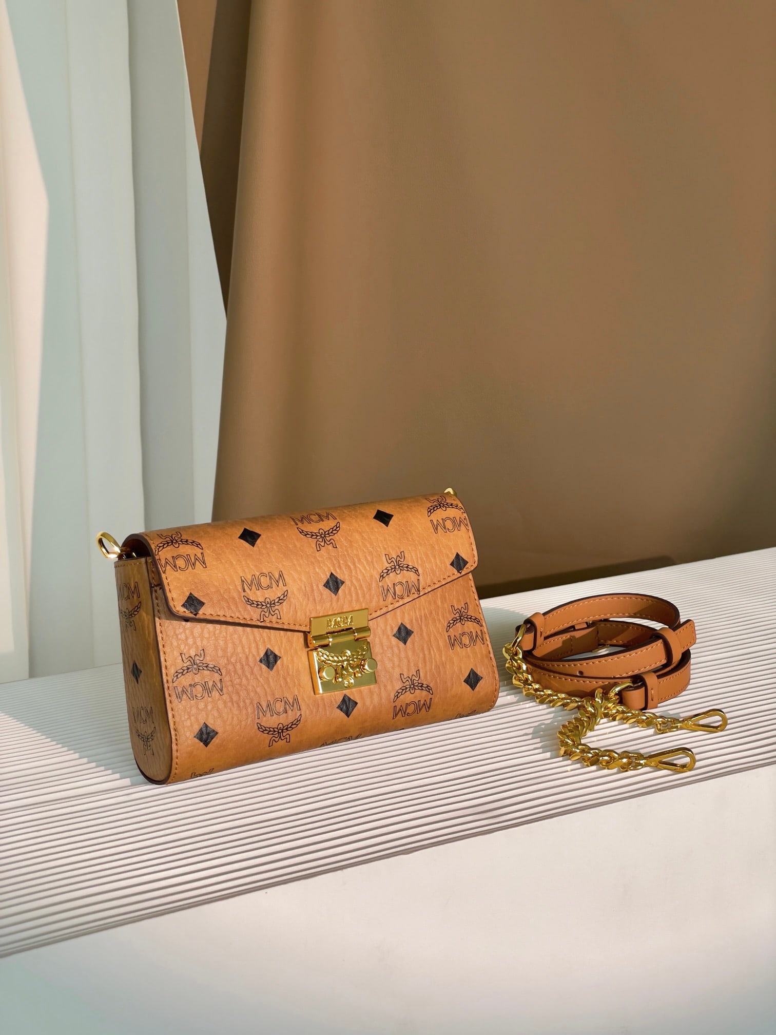 MCM TARCY VISETOS Small Chain Envelope Bag: MCM TARCY VISETOS Small Chain Envelope Bag with All-Over Monogram Print. This exceptional Tracy crossbody bag is crafted from Italian Visetos and Nappa leather. This classic tote bag features the