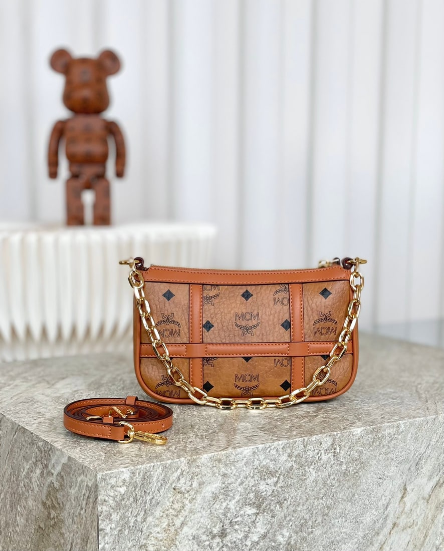 MCM AREN VISETOS Chain Shoulder Strap Crossbody Bag: MCM AREN VISETOS Chain Shoulder Strap Crossbody Bag in Classic Cognac. This mini Aren shoulder bag is crafted from the classic Visetos, creating a sophisticated aesthetic. The refined bag is adorned w