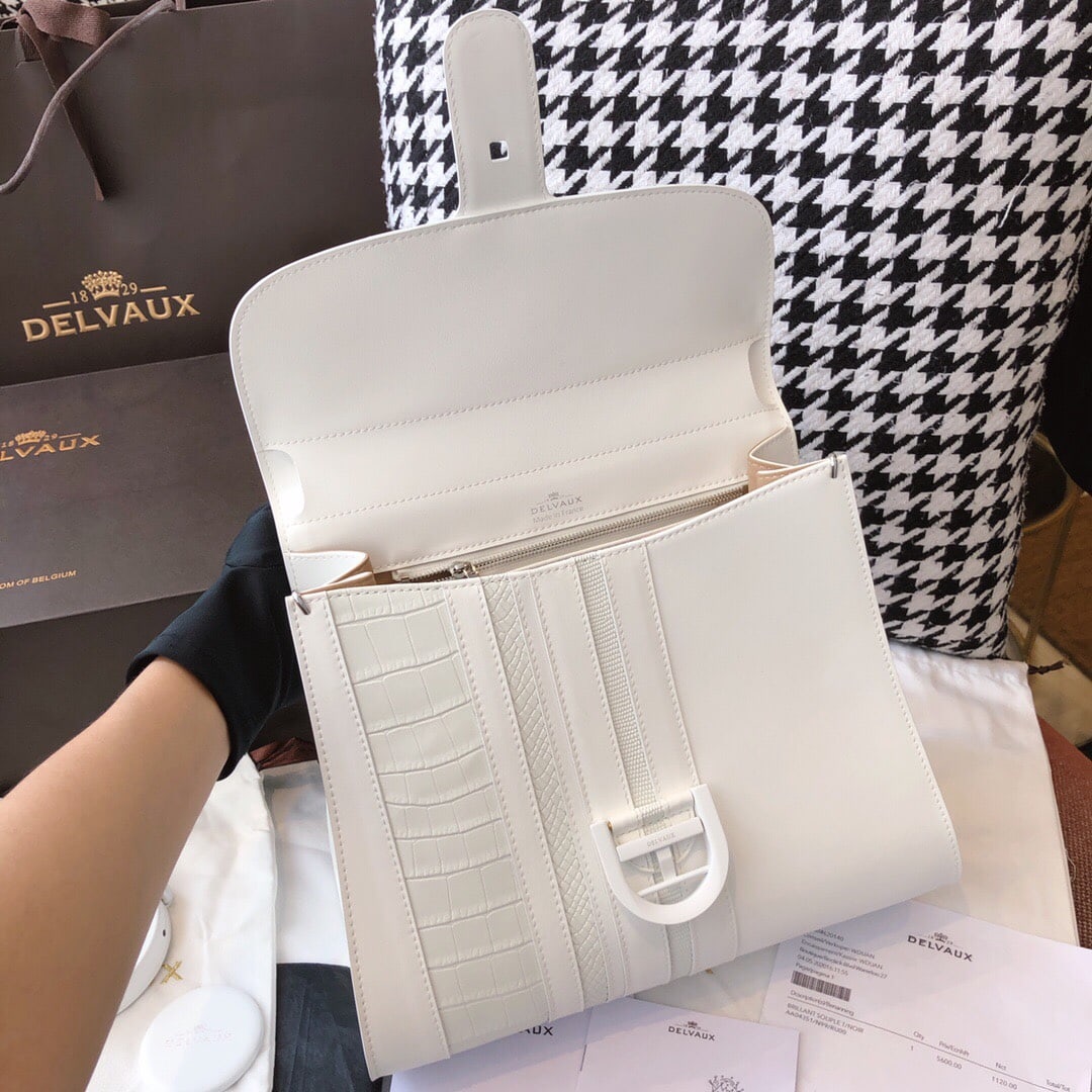 Delvaux Sporty Stripes Noir & Ivory Brillant: Delvaux, a Belgian brand of vintage luxury, presents the Sporty Stripes Noir & Ivory Brillant MM classic handbag. Made of box leather with stainless steel hardware, it features a unique D-shaped clasp