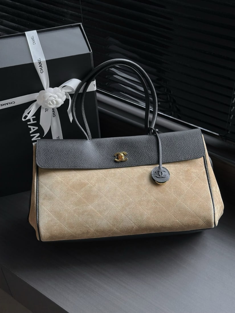 CHANEL suede and leather baguette bag: This suede and leather baguette bag features a combination of black cowhide and beige suede, a classic quilted pattern, and a gold double-C clasp, exuding a retro and elegant charm. The baguette shape