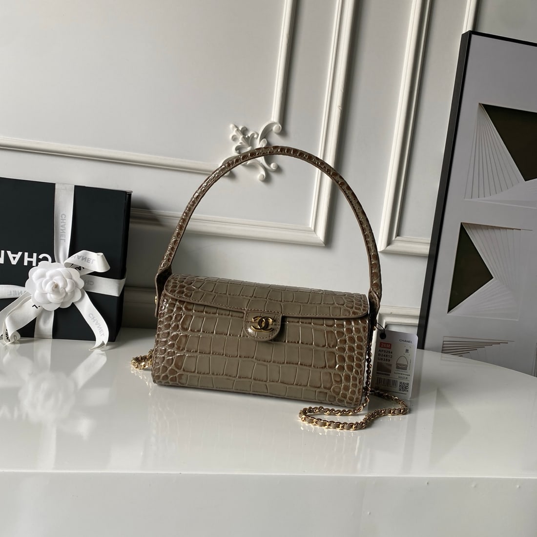 CHANEL Retro Handle Bowling Ball Commuter Bag: This CHANEL vintage-style bowling bag features a crocodile-embossed design with a light gold double-C twist clasp. It blends the elegance of a vintage handbag with a modern chain strap, while the chai